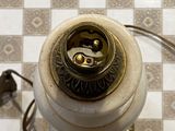 an overhead view of a lamp on a checkered floor