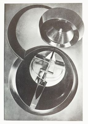 a black and white photo of a clock on a table