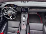 the interior of a sports car with red trims and black leather seats