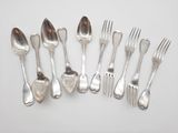 a lot of silver spoons and forks on the table