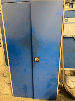 a blue refrigerator that is sitting in a garage