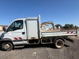 a white truck that is parked in the dirt