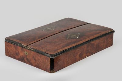 an old wooden box with two compartments on top of it