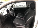 the interior of a small car with two seats and a steering wheel