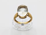 an image of a gold ring with a white diamond on it