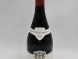 la bouteille de vin rouge est posée sur une surface blanche