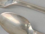 two spoons and a fork on a table