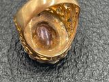 an image of a gold ring with a stone inside of it