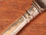 a knife on a wooden table with a metal handle