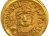 une pièce d'or à l'effigie d'un homme coiffé d'une couronne