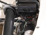a close up of a car ' s engine with wires attached to it