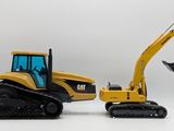 two toy excavators sitting next to each other on a white surface