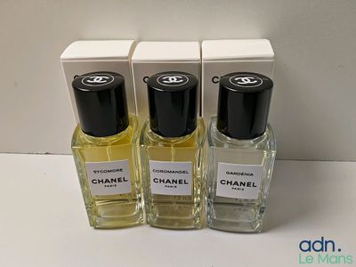 three bottles of chanel perfume sitting next to each other