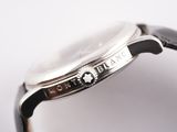 a close up of a watch on a white surface