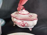a white plate with a pink feather on top of it