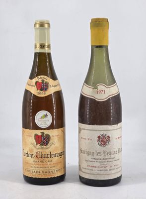 two bottles of wine sitting next to each other on a white surface