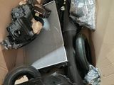 a cardboard box with a car engine and other items in it