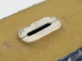 a small hole in the side of a piece of wood