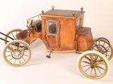 a small wooden horse drawn carriage on a white background
