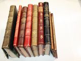 several old books are stacked on top of each other on a table