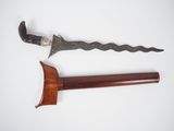 an old dagger with a wooden handle on a white surface