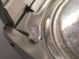 a close up of a watch with a metal band