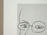 a drawing of a man with glasses and a beard on a piece of paper