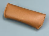 a close up of a brown leather case on a blue surface