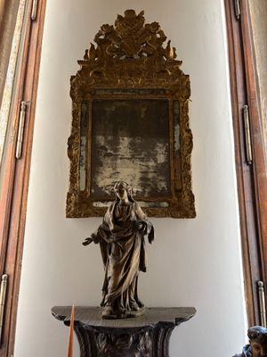 a statue of a woman holding a child in a room