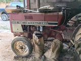 a red tractor that is parked in a garage