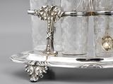 a silver plate with a glass holder on it