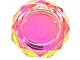 brightly colored glass ashtray on a white background with reflection