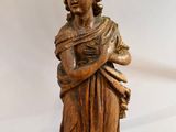 an antique wooden statue of a woman holding a baby