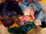 a pile of clothes and other items on a bed