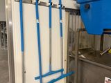 a blue bucket and blue brooms hanging on a wall