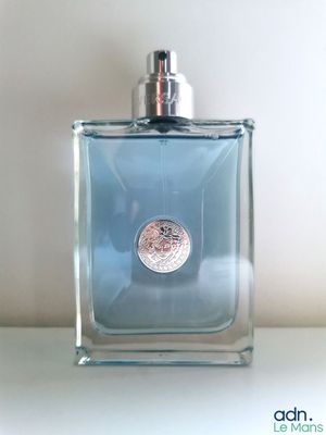 an image of a bottle of perfume on a table