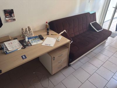 a couch and a desk in a living room
