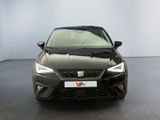 the front view of a black car in a white room