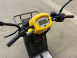 a yellow motorcycle with a digital display on the handlebars