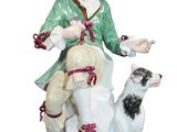 figurine of a woman with a dog on a white background