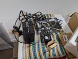 a pile of assorted electronic equipment on a table