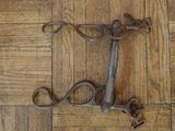 a pair of scissors sitting on a wooden floor