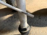 a close up view of a white toilet with a broken seat