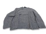 Le pull est gris et a des manches longues.
