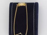 an image of a gold bracelet with a chain on a blue velvet case