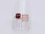 a close up of a ring with two different colored stones on it