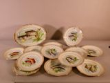a lot of plates with fish on them on a table