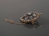 an image of a broochle with a chain attached to it