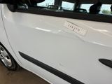 a small white car with a sticker on the side of it