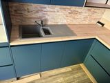 a kitchen with blue cabinets and a sink in it
